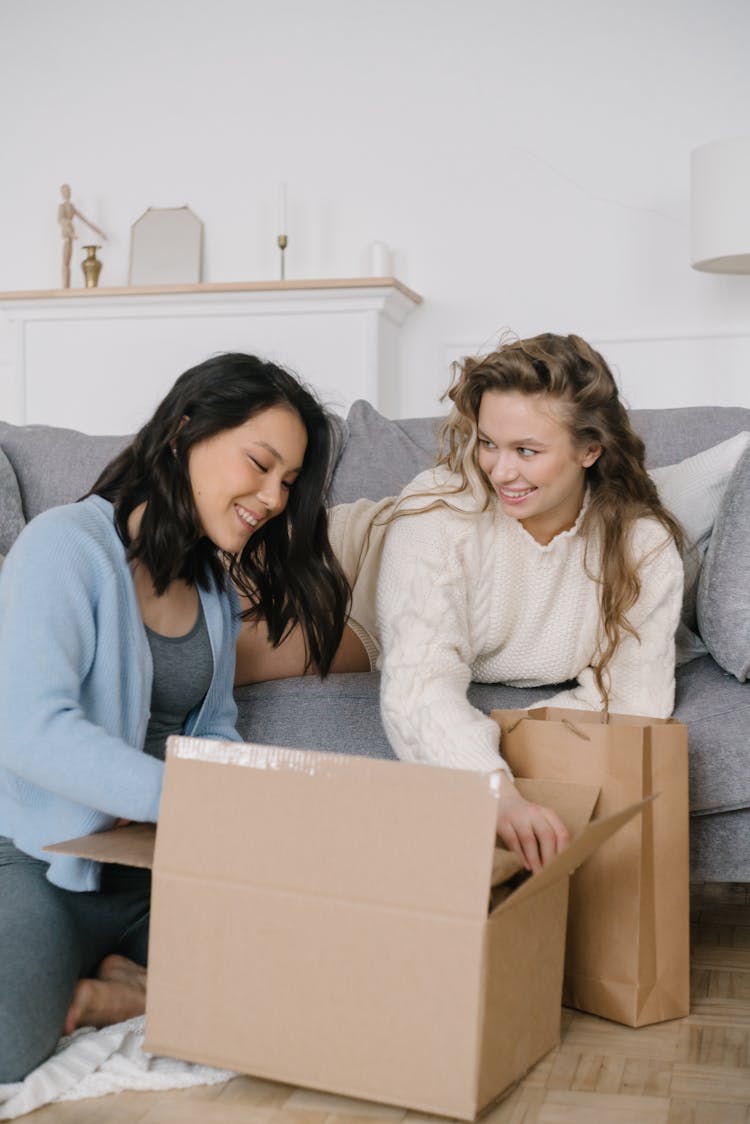 Two Women Opening A Box