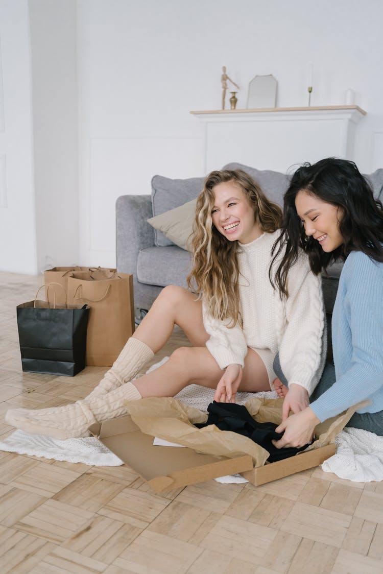 Two Women Opening A Box