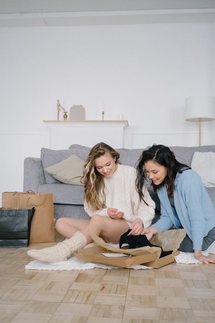 Two Women Opening A Box