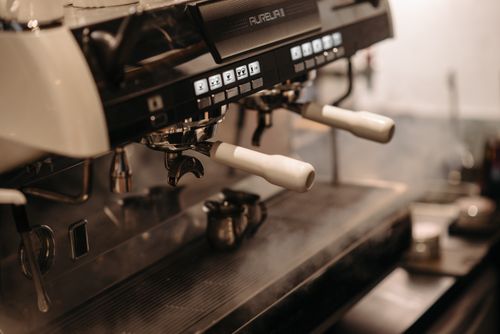 Free Close-up of a professional espresso machine in a cafe, showcasing sleek design and controls. Stock Photo