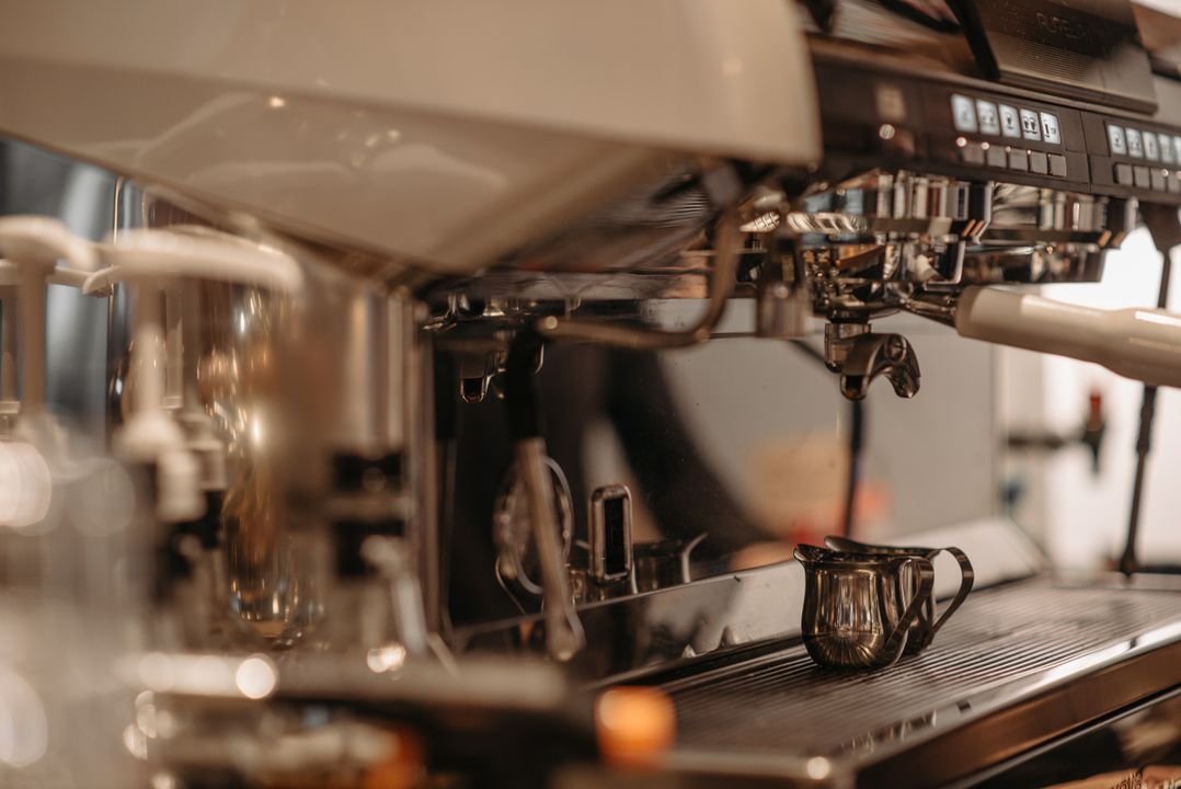 Commercial coffee machine on a service bar with espresso being prepared