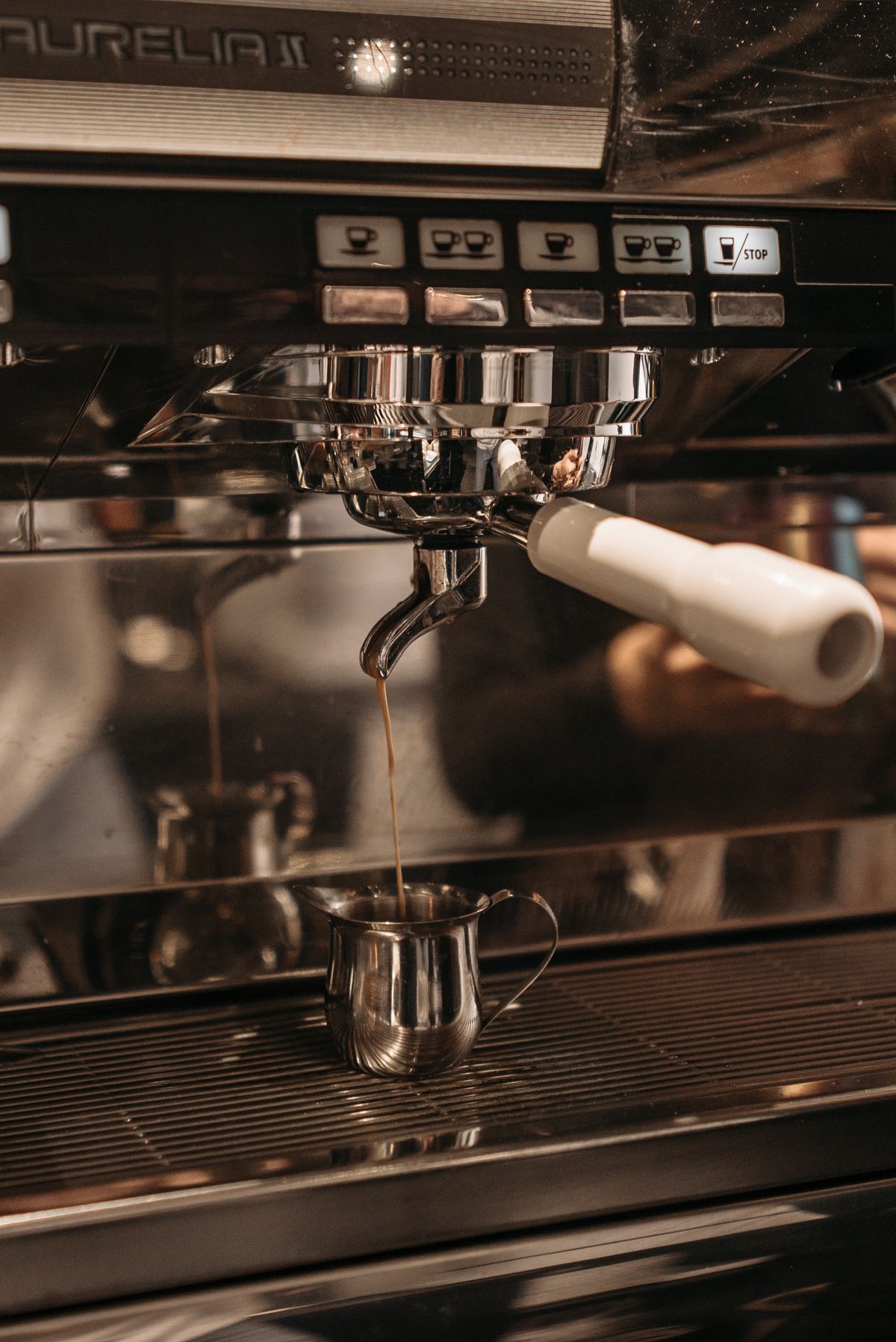 Close-up of a professional chrome espresso machine, for illustration