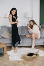 2 Women Sitting on Gray Couch
