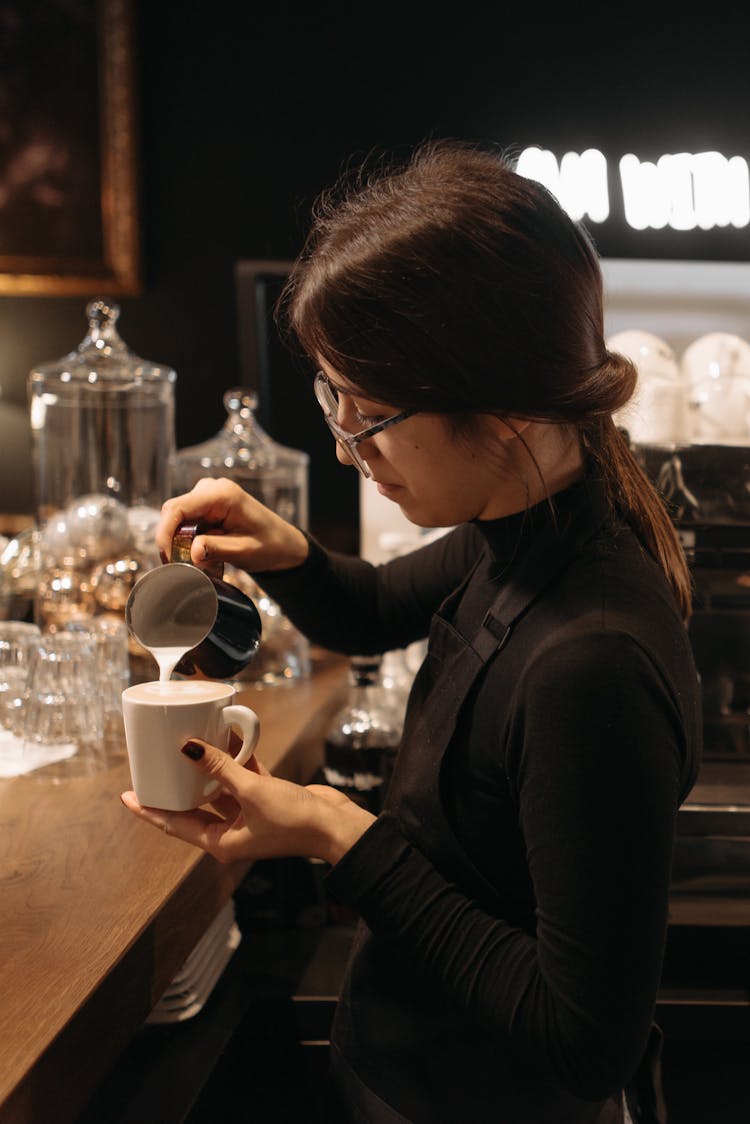 A Woman Making Coffee Drink In A Cup