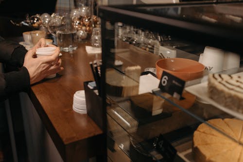 Hands Putting Cover on the Disposable Cup 