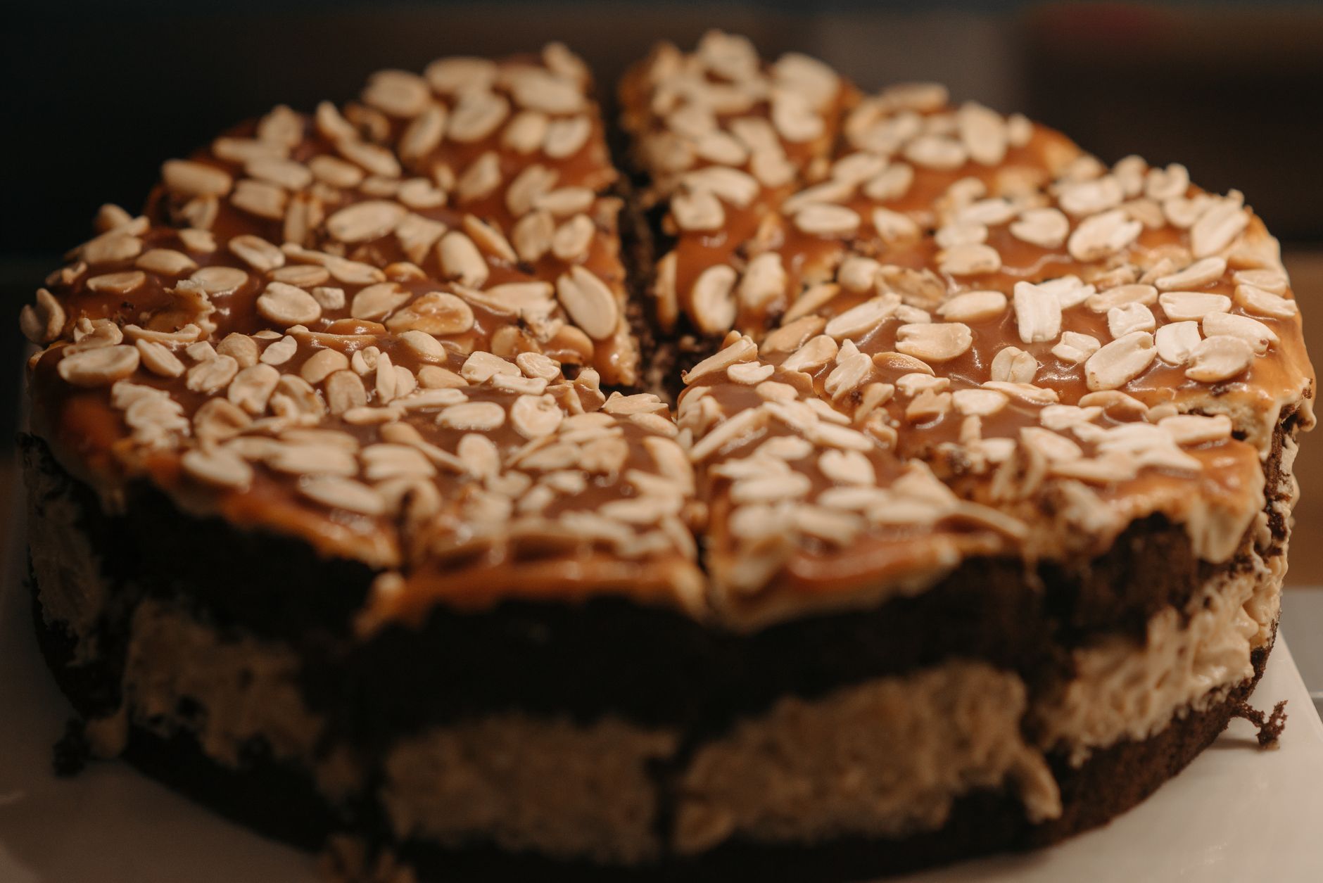 Homemade graham cracker cake with peanut butter frosting on a wooden table