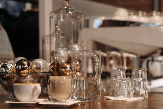 Warm indoor setting with coffee cups and holiday decorations, perfect for festive moments.