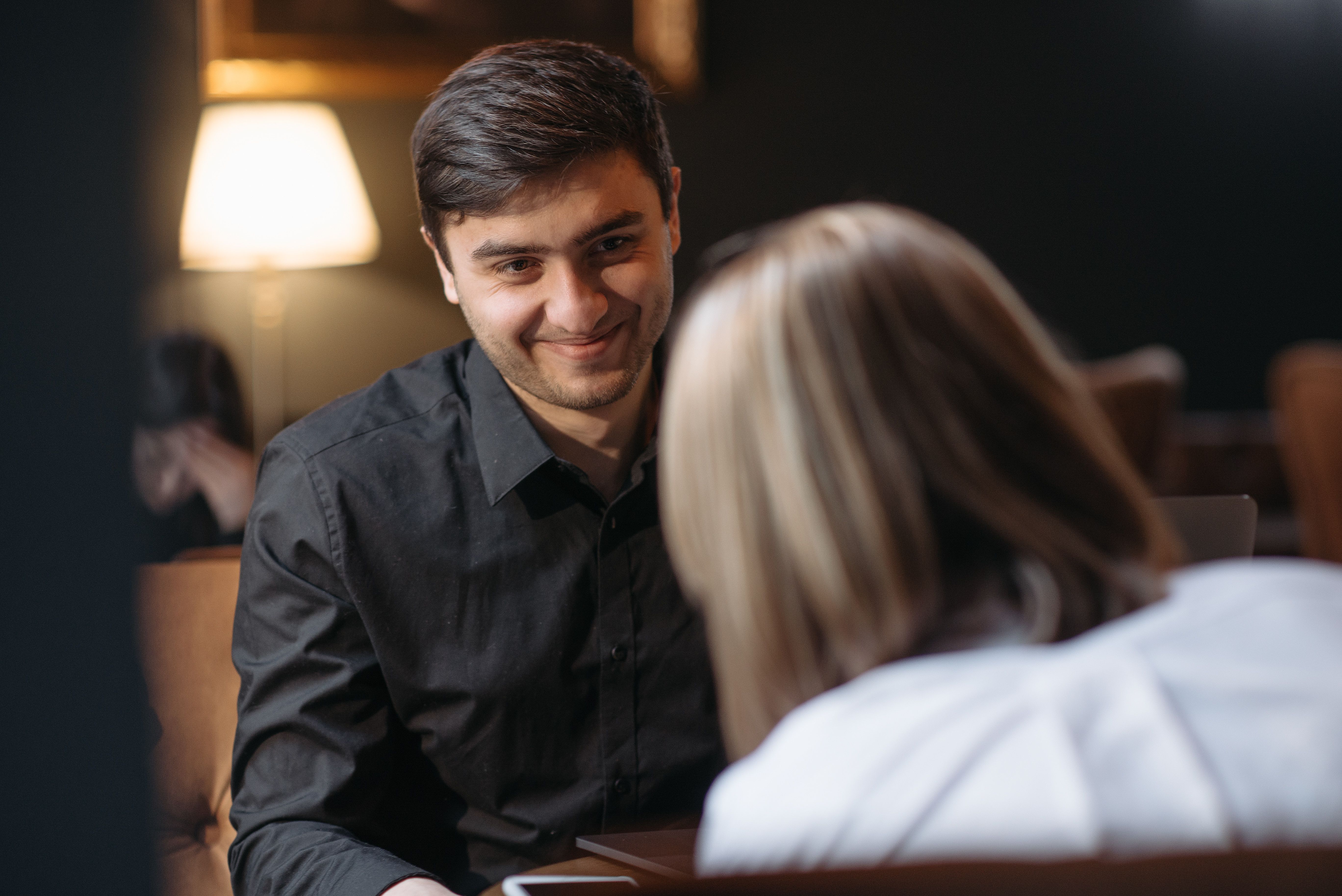 two people having friendly conversation coffee meeting check-in