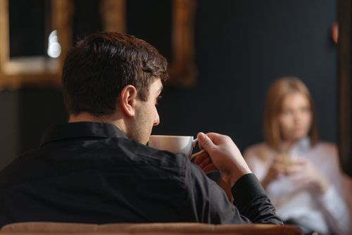 Free A man sits in a cafe, enjoying a warm drink, creating a relaxed atmosphere. Stock Photo