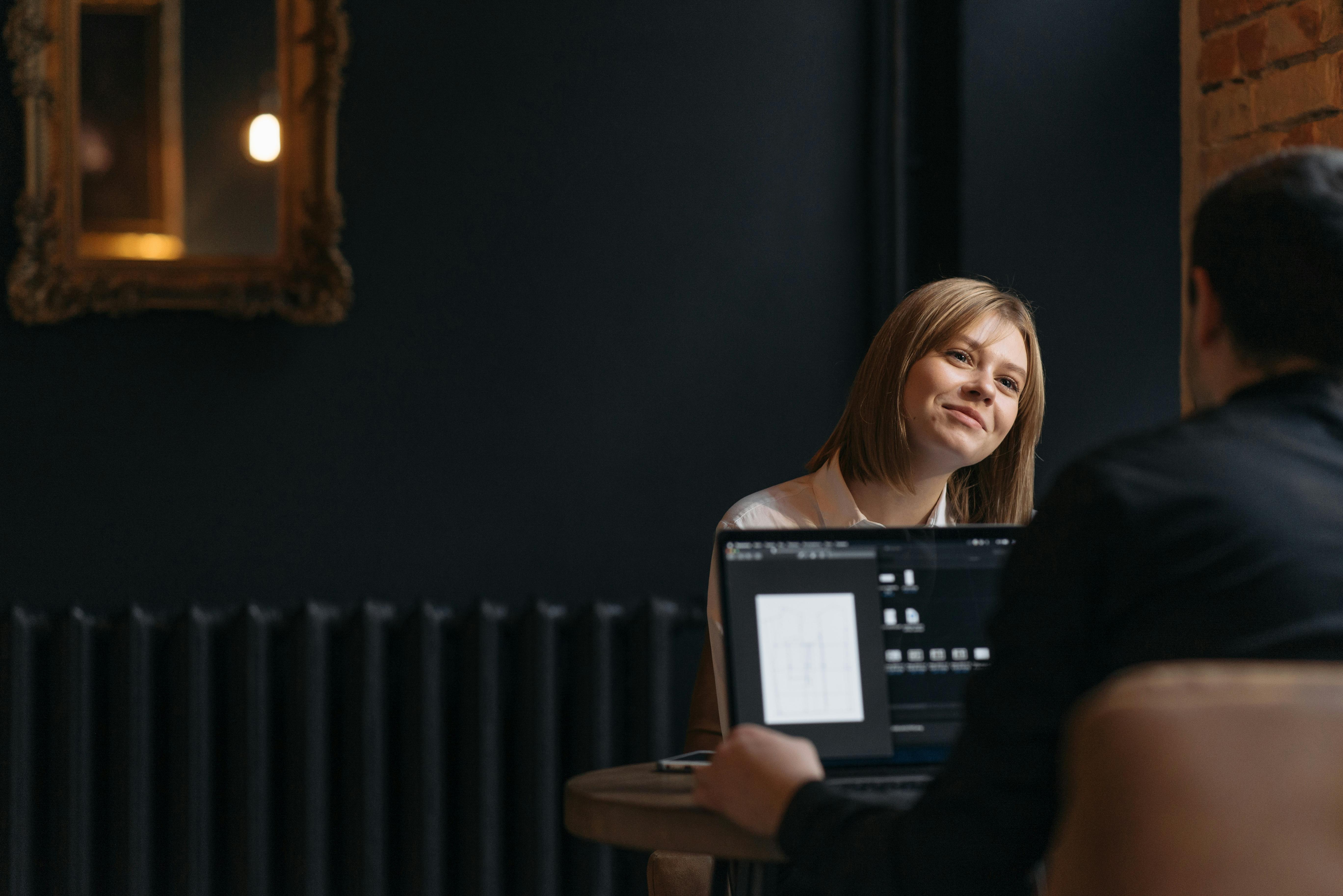 a woman smiling looking at man