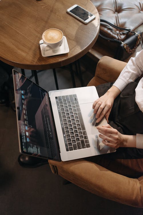 Free A Person Scrolling on a Laptop Stock Photo