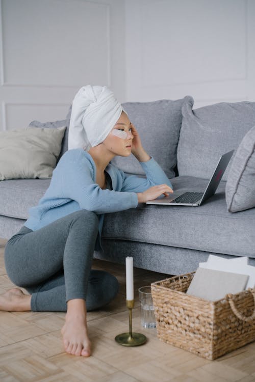 Free Woman Sitting on the Floor While Using a Laptop Stock Photo