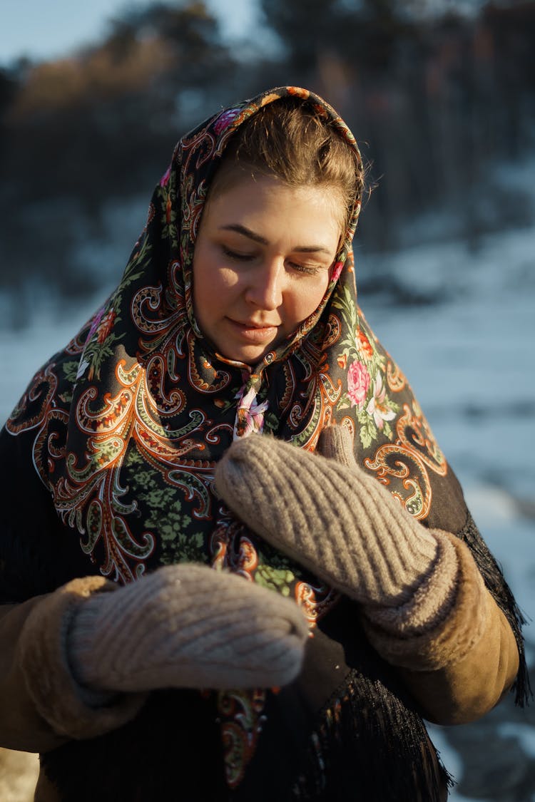 A Woman Earing Headscarf And Gray Mittens