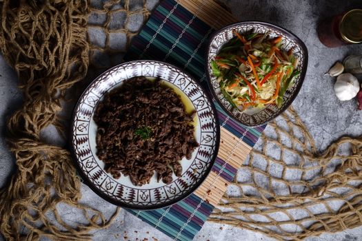 Delectable top view of Filipino beef tapa paired with vibrant mixed vegetables.