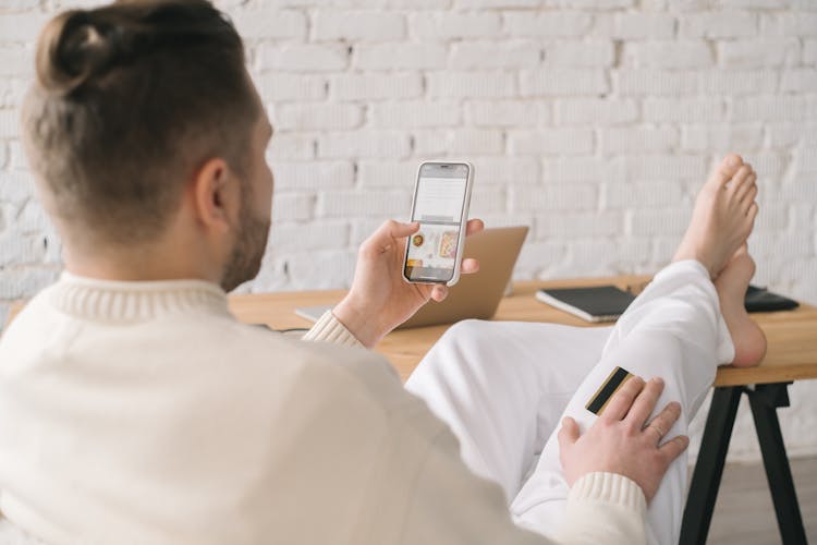 A Person In White Clothes Buying Online