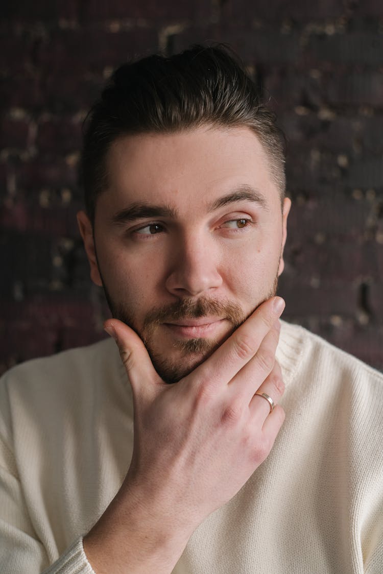 A Man Touching His Jaw While Thinking