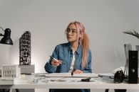 Woman in Blue Denim Jacket Sitting at the Table