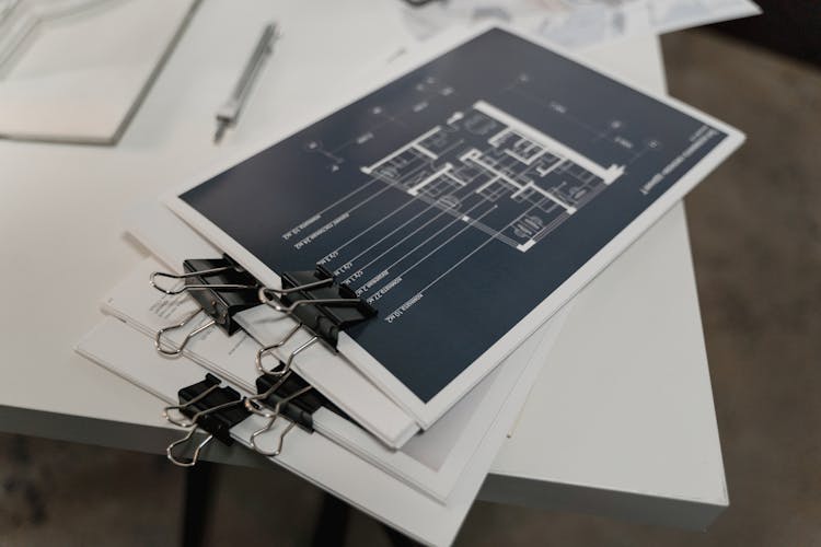 Pile Of Documents On White Table