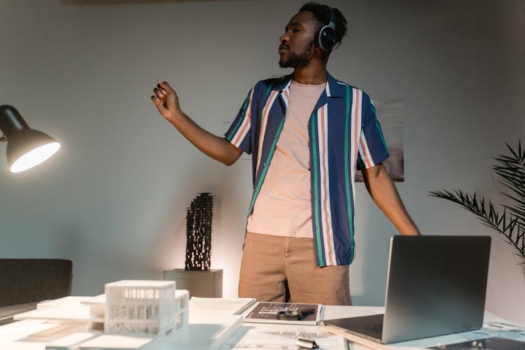 A Man With Headphones Listening To Music