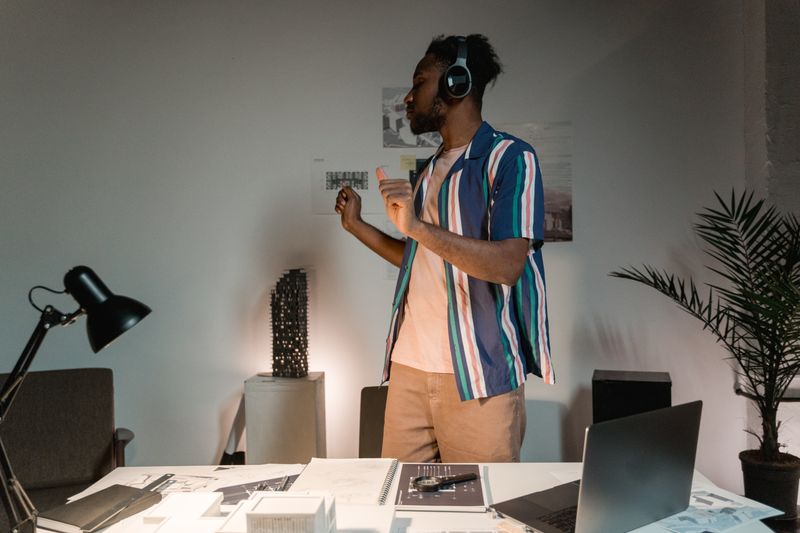 Man wearing wireless headphones in a home office environment