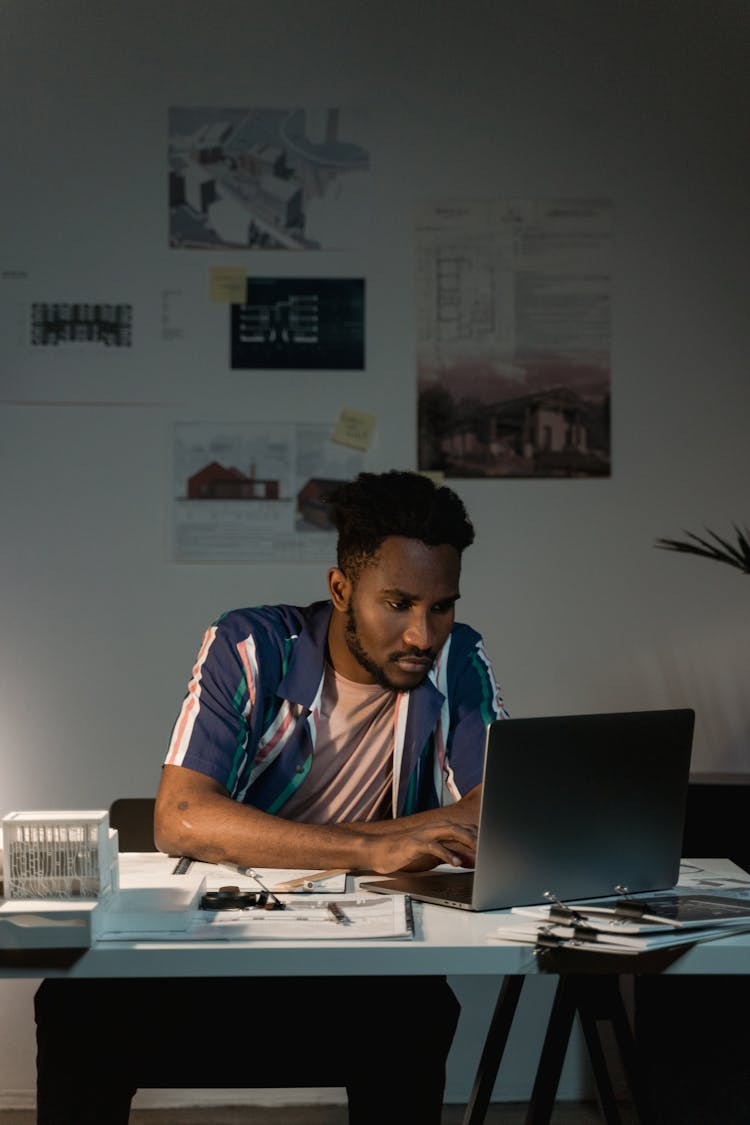 A Man Busy Working On His Laptop