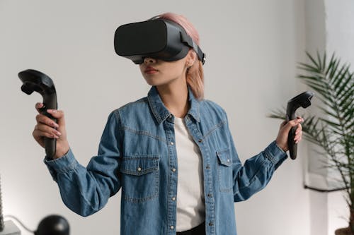 A Woman in Denim Jacket Playing Virtual Reality