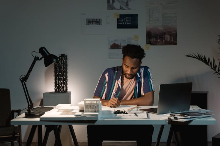 A Man Busy Working On His Table