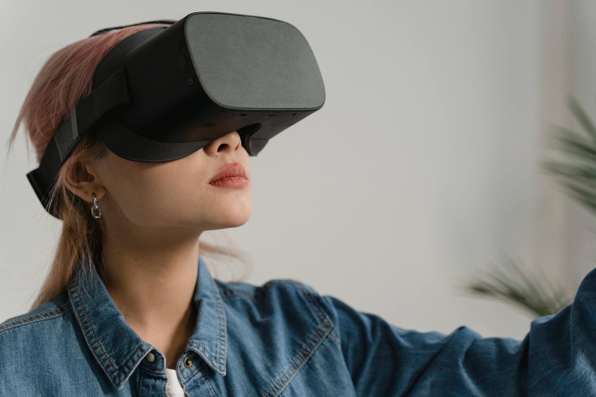 Young Woman in Denim Jacket Wearing a Virtual Reality Headset