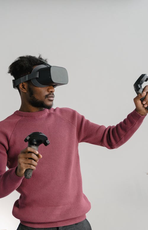 A Man in Pink Sweater Using Virtual Reality Game 