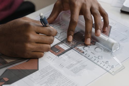 A Person Drawing a Blue Print