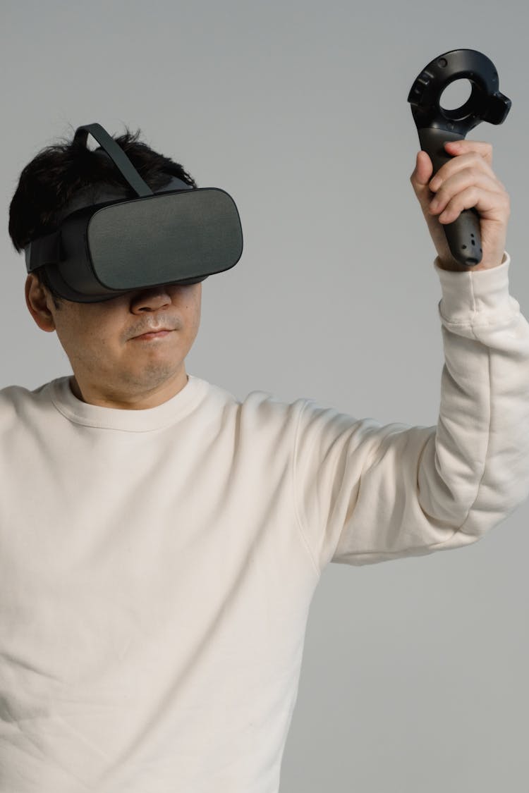 Man Playing Video Game Using An Oculus Virtual Reality Headset 