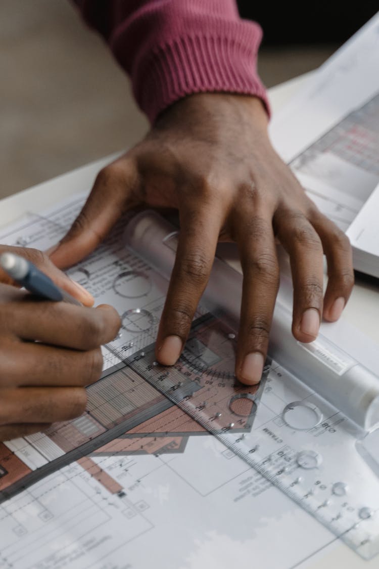 Person Holding Ruler And Pencil