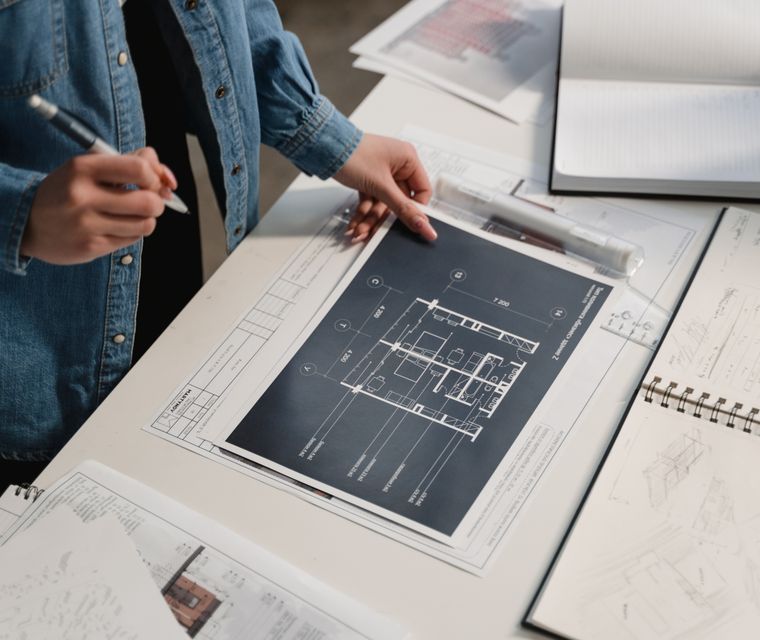 Drafter holding a printed floor plan