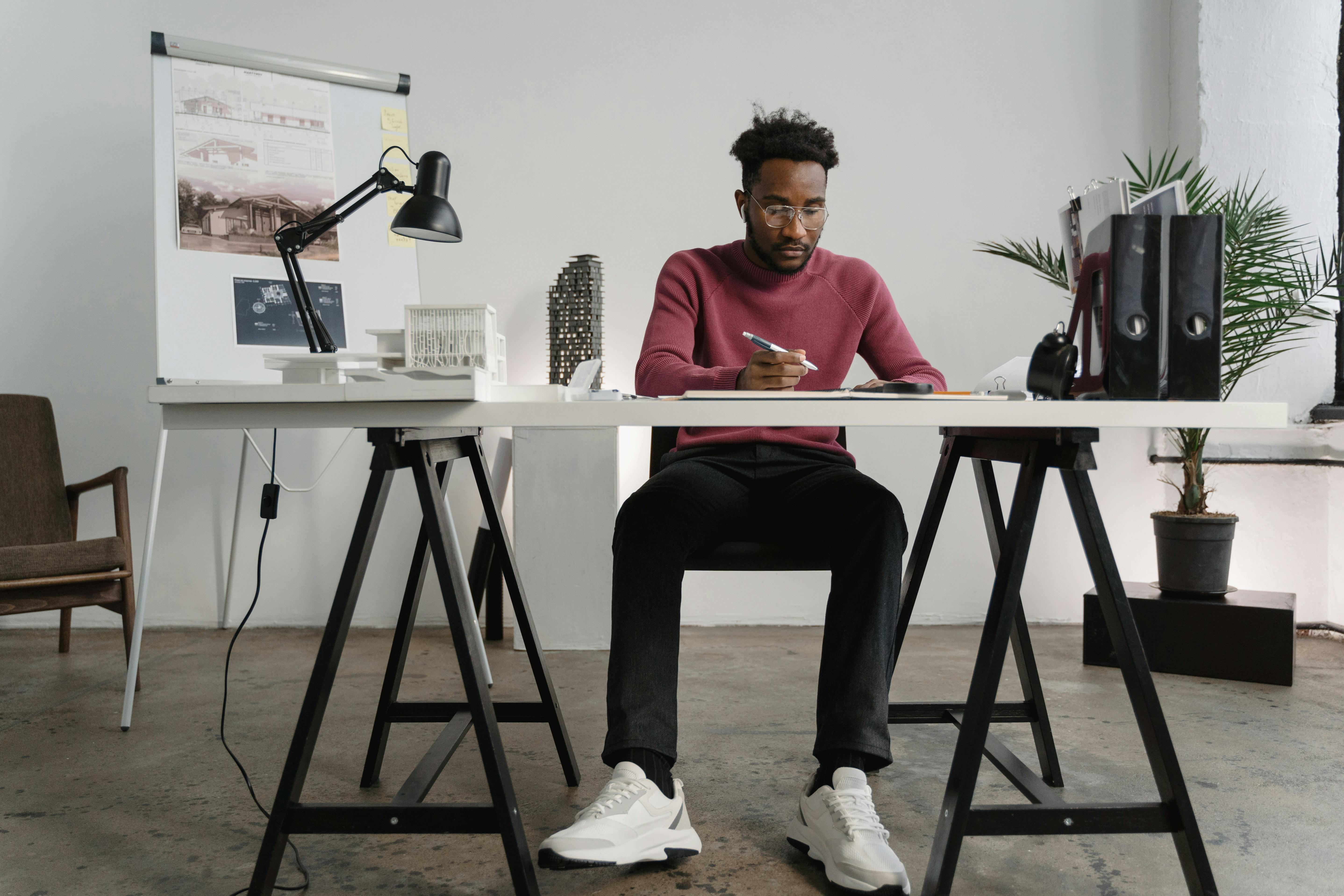 young man sitting on chair in office