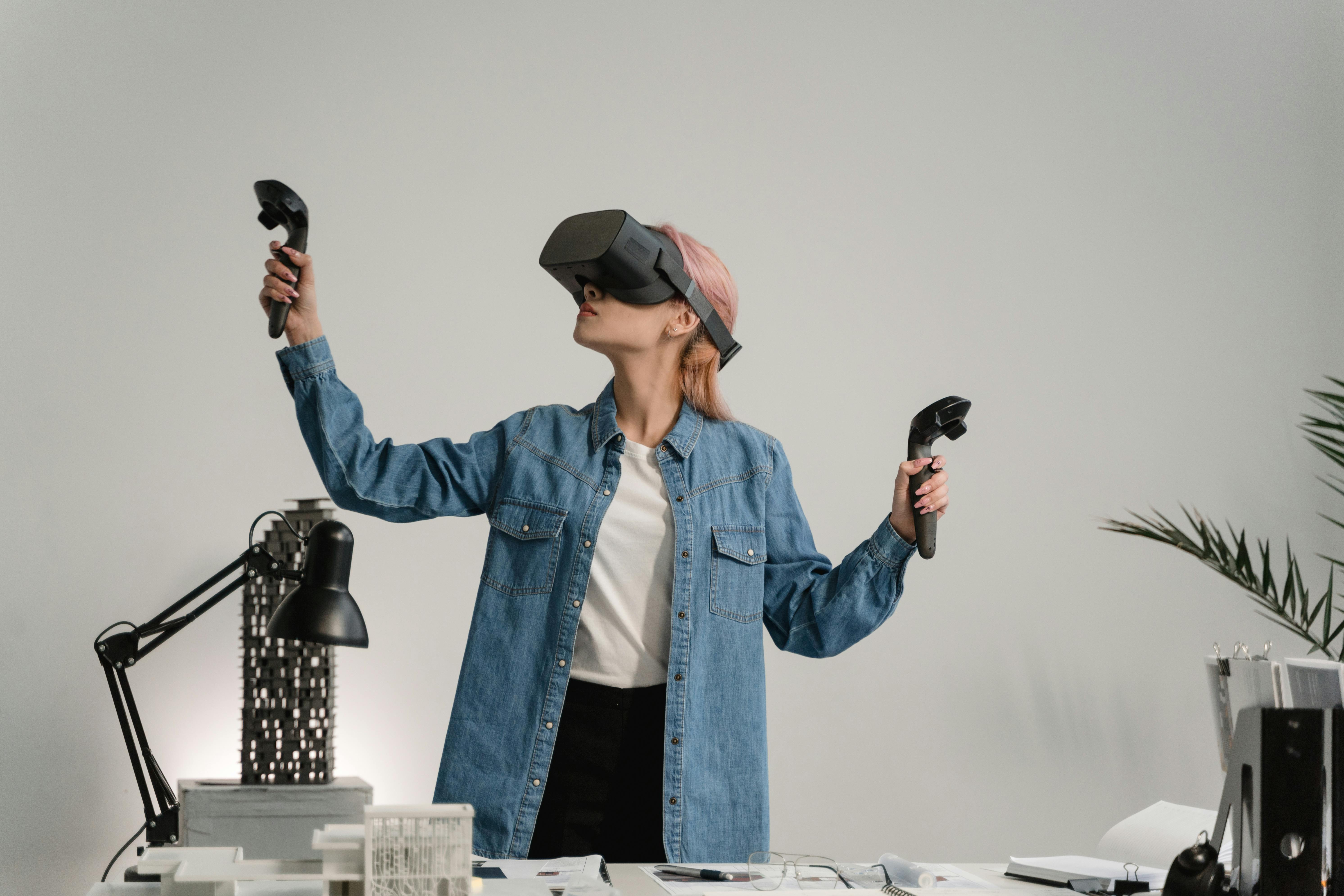 woman in blue denim jacket holding black dslr camera