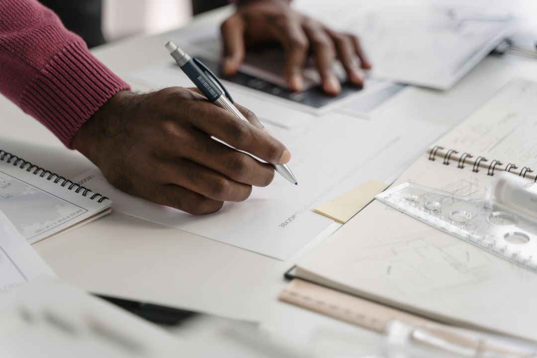 architect working on blueprints at a desk