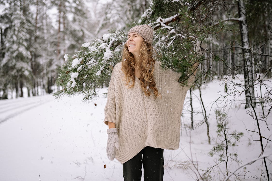Woman Standing Under a Tree Branch with Snow · Free Stock Photo