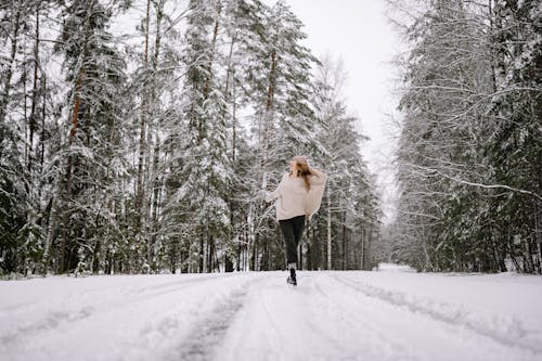Woman Running in Winter Forest