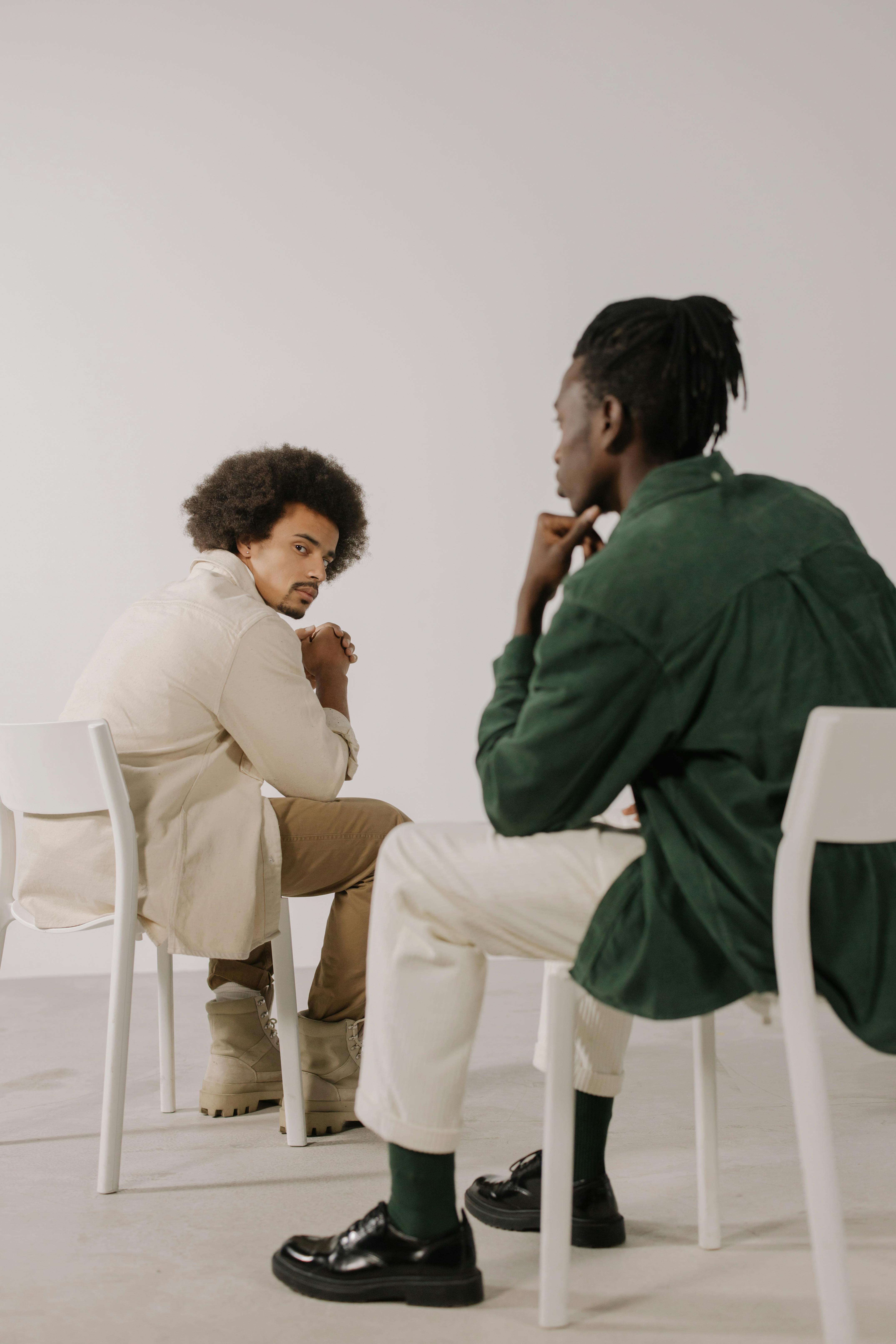 handsome men sitting on chairs