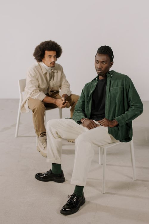 Free Two stylish men posing in a modern studio setting, showcasing contemporary fashion. Stock Photo