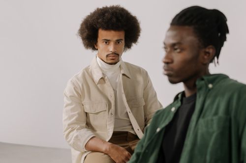 Free A portrait of two stylish men with afro hairstyles in casual wear against a white background. Stock Photo