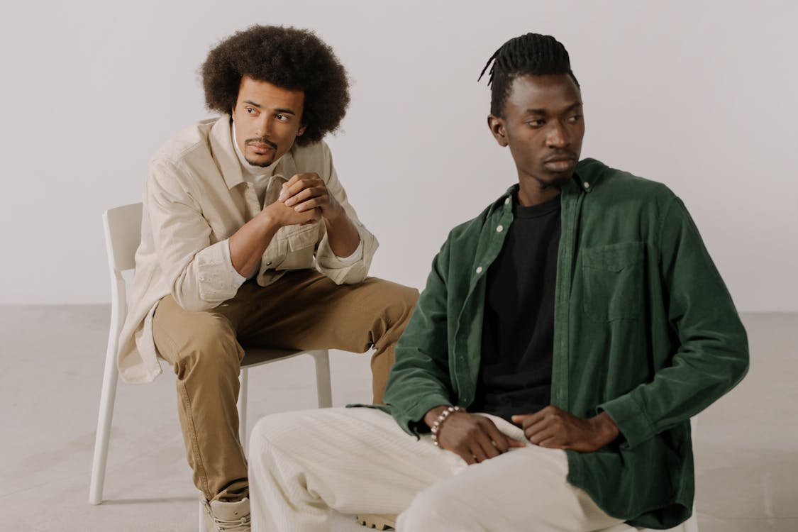 Two Men in Stylish Shirts Posing in a Studio