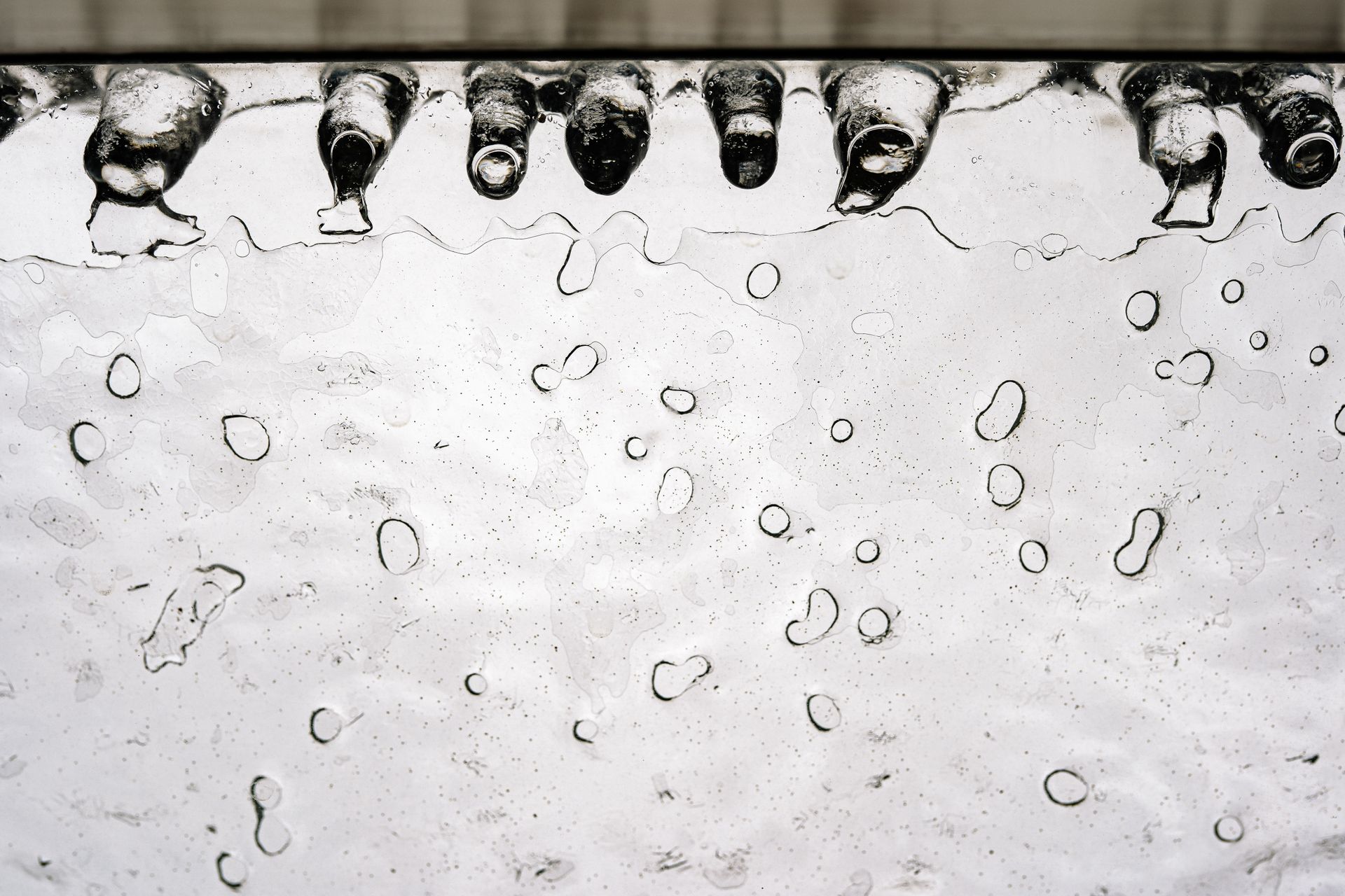 Detailed close-up of icicles with a melting surface, capturing the texture and depth of frozen water.