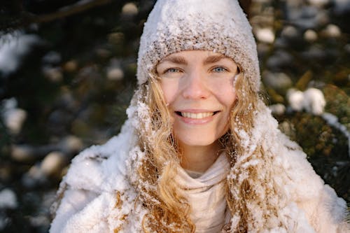 Free Selective Focus Photo of a Woman with Snow on Her Hair and Cap Stock Photo