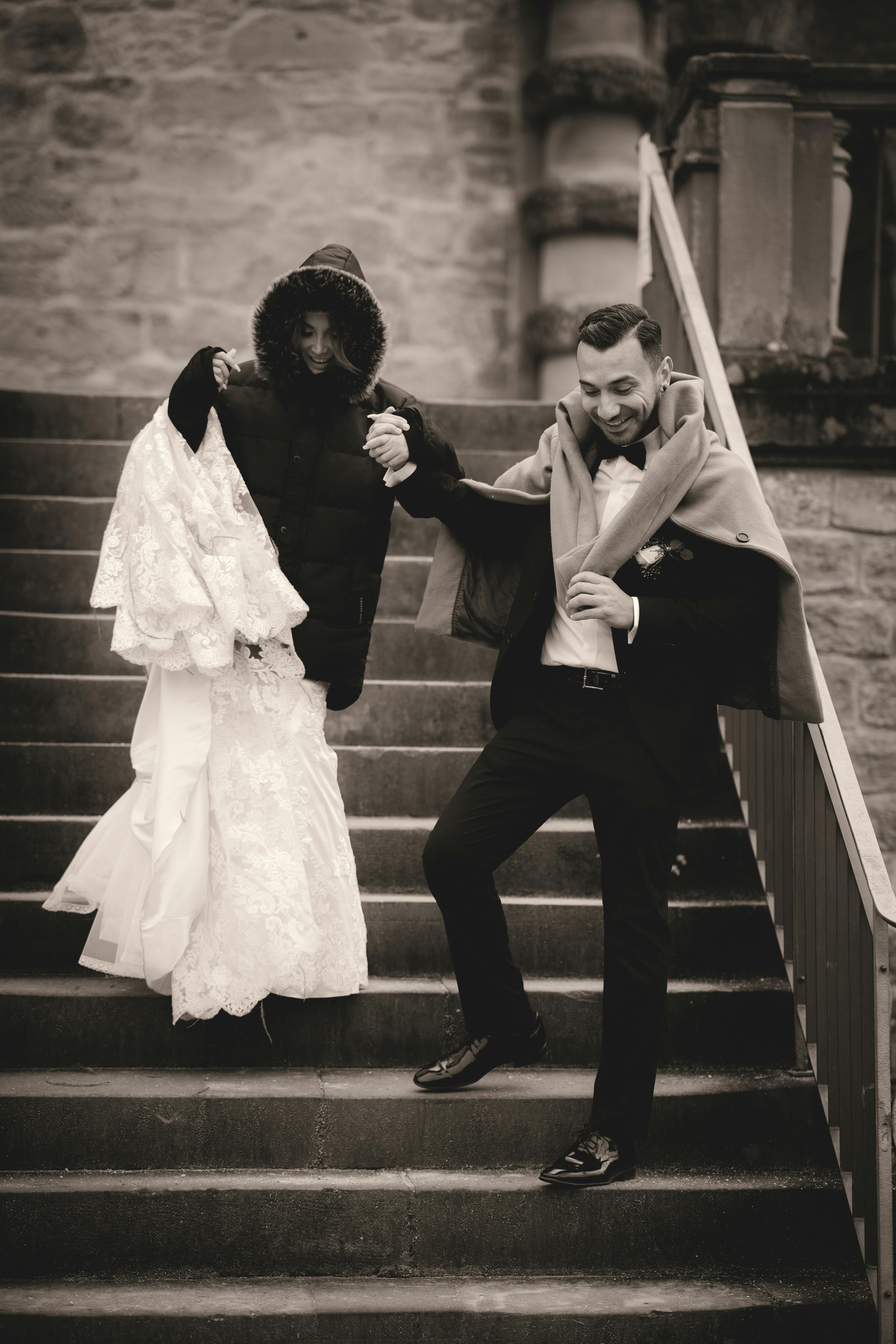 man and woman kissing on stairs