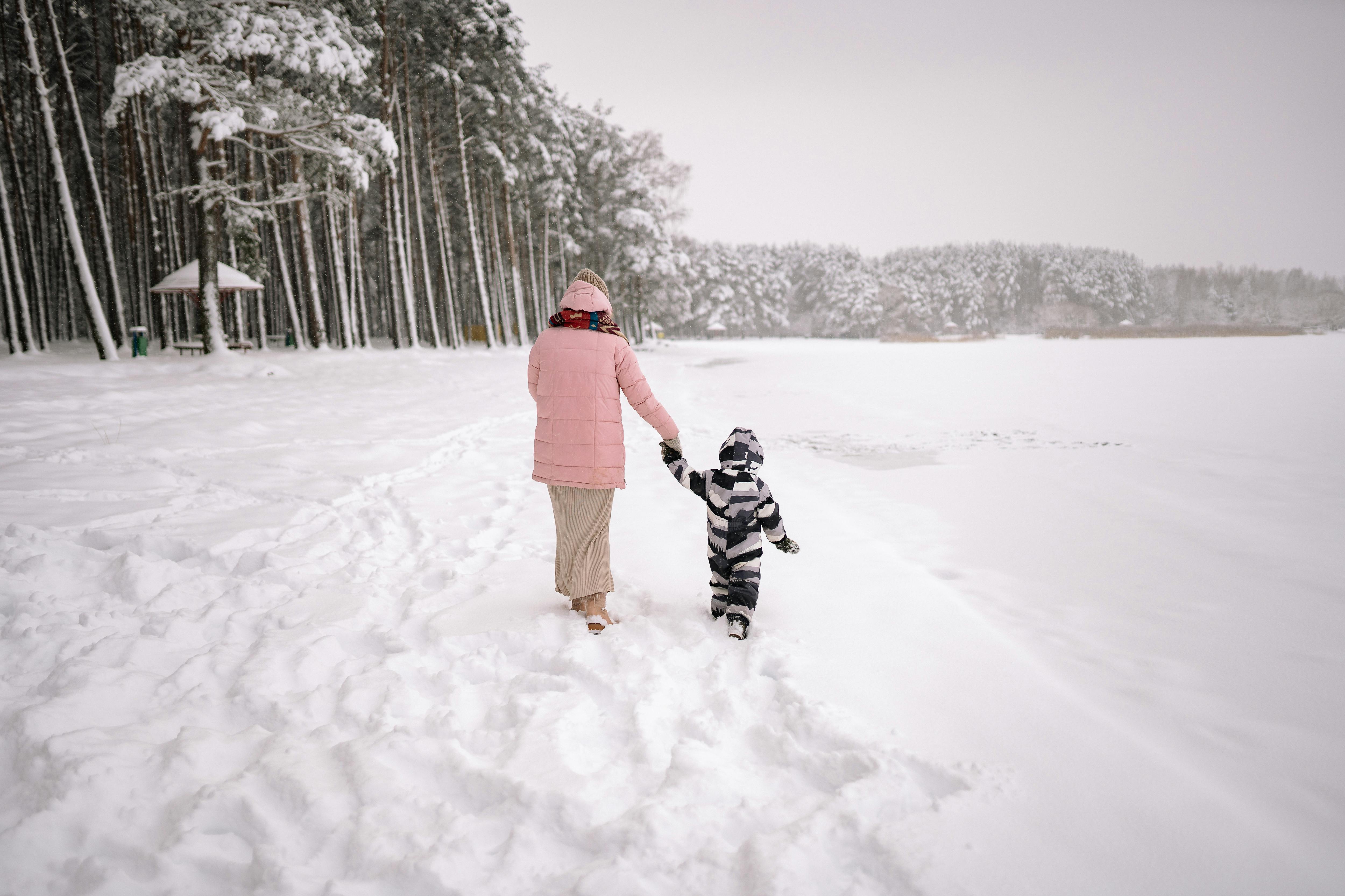 mother and son walking in a snow