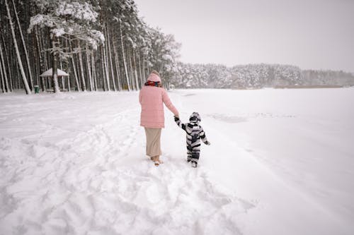 Mother and Son Walking in a Snow 