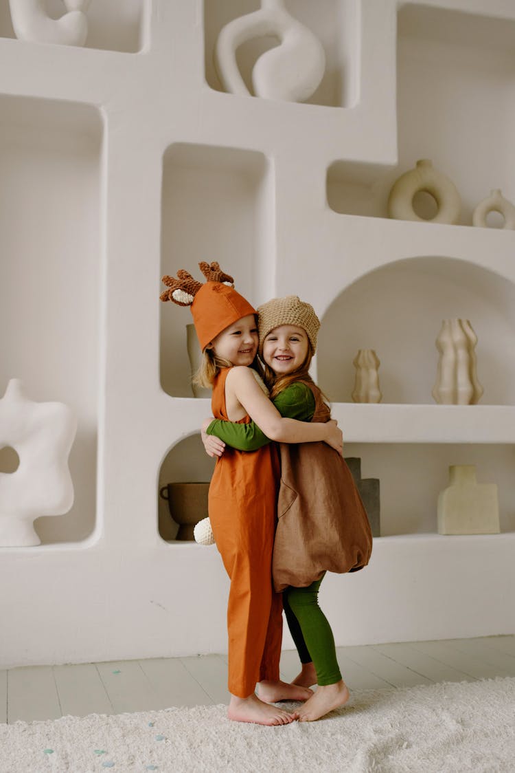 Two Girls In Costumes Hugging Each Other