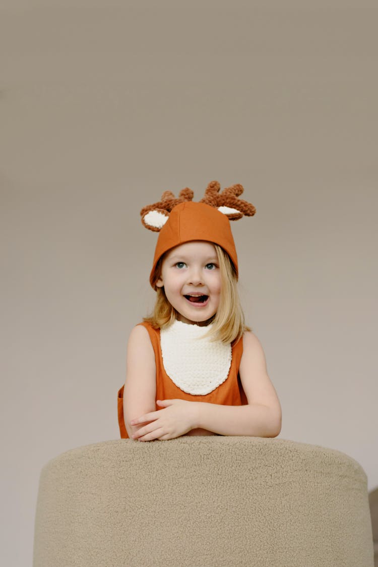 A Girl With Blond Hair In Reindeer Costume