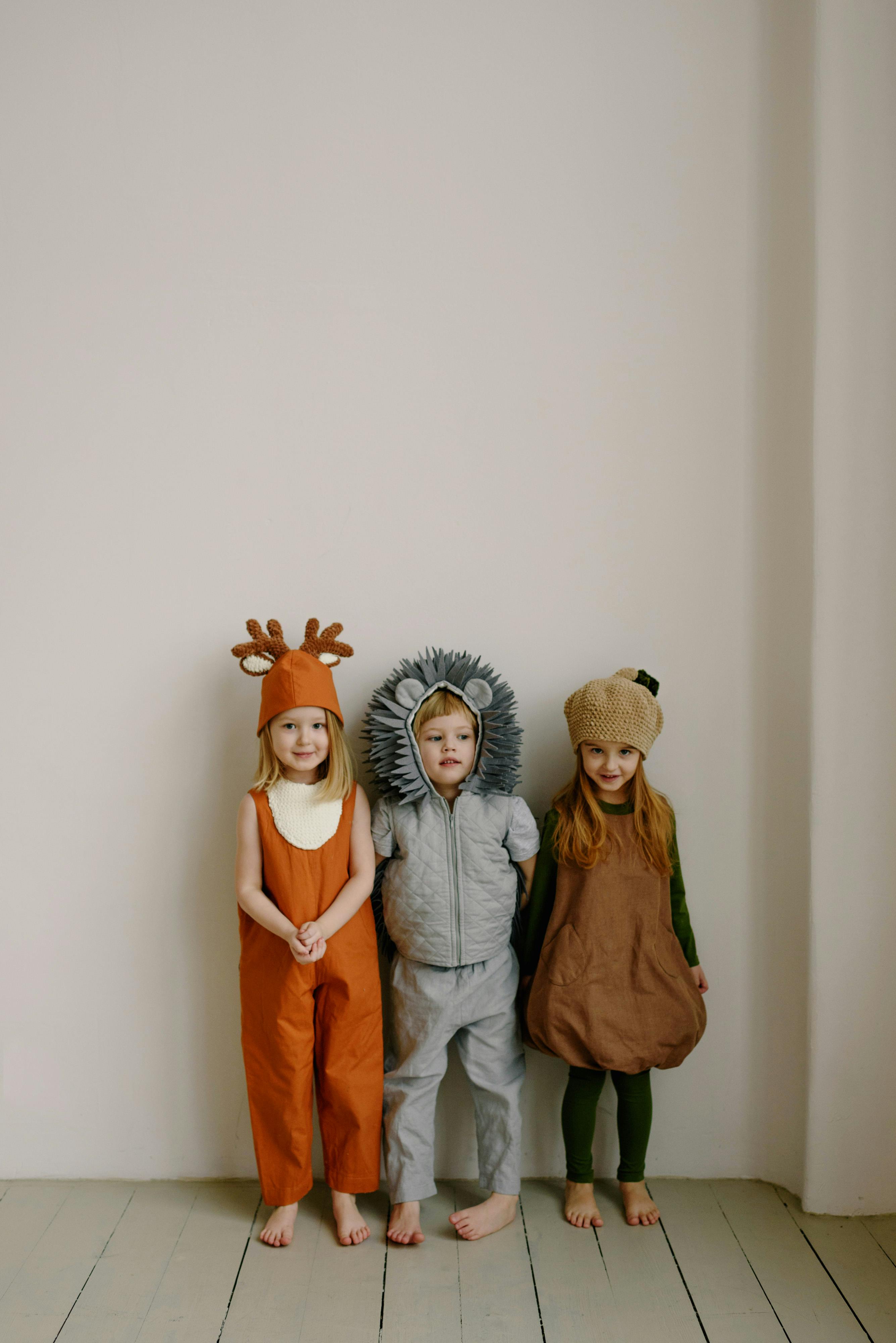 kids wearing costume standing next to each other